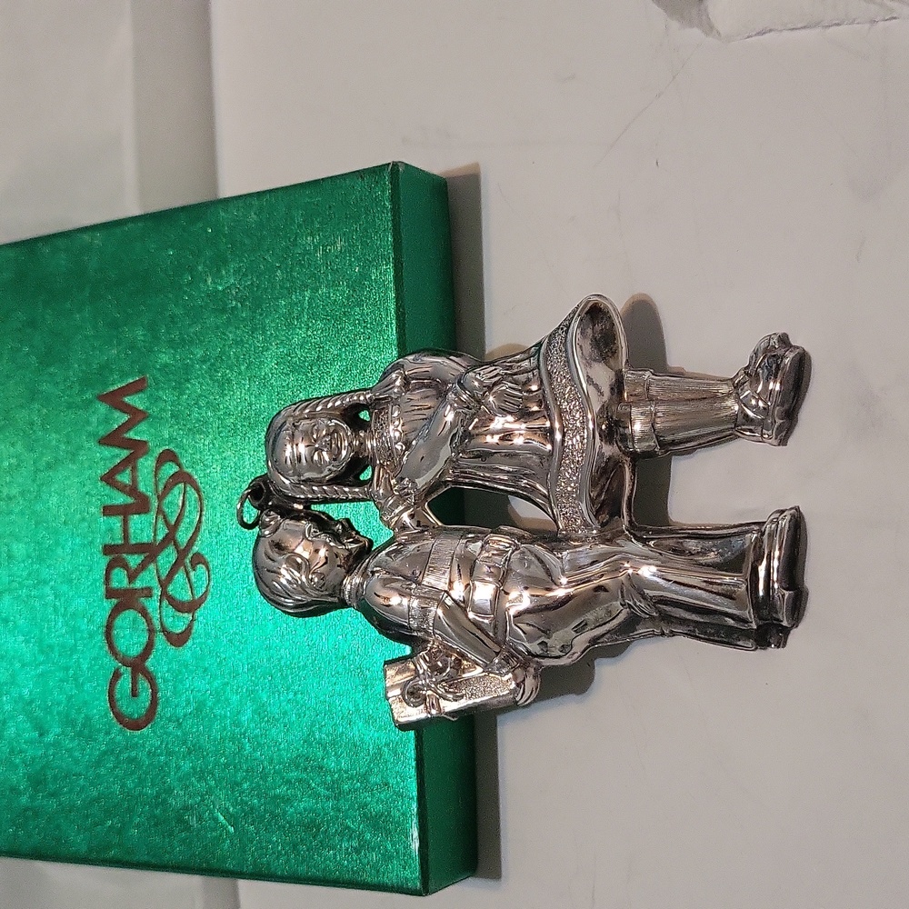 Gorman silver plate Christmas ornament of little boy giving little girl a presen